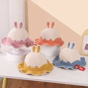 Detail of four colorful corduroy baby bucket hats with cute bunny ears and Heart labels