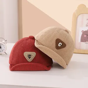 Kids corduroy beanie hat with leather C patch in deep red and beige minimalist style