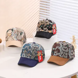 Detailed view of four kids cartoon bear baseball caps with animal patterns and embroidery