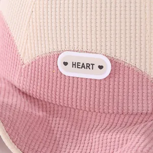 Close-up of pink corduroy kids bucket hat featuring heart embroidery and soft texture