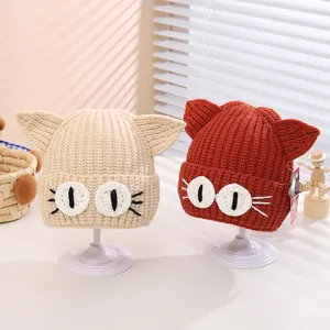 Detailed close-up of cute cat ears and knitted texture on children's winter beanies