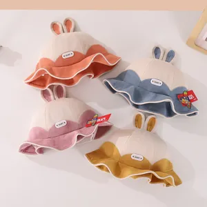 Top view of four colorful toddler bunny ear bucket hats in corduroy with HEART label
