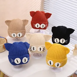 Detail showing various colors of knitted cat ear hats with thick warm texture