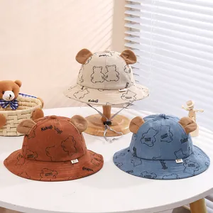 Three corduroy baby bucket hats with bear ears in beige, caramel, and blue colors