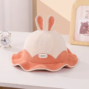 Detailed macro view of cute rabbit ear decoration and corduroy fabric on baby bucket hat