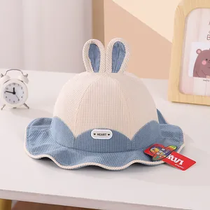 Close-up of corduroy rabbit ear bucket hat with HEART embroidery and soft texture