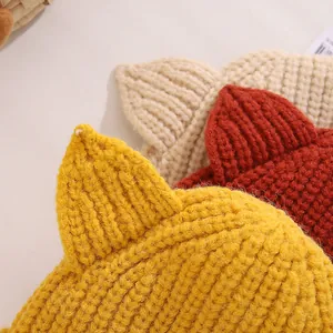 Detailed texture of thick knit winter hats with cute 3D cat ears in multiple colors