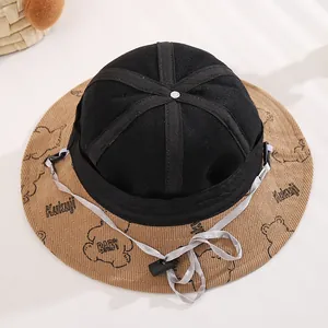Detailed top view of a baby bear bucket hat featuring corduroy brim and windproof chin strap