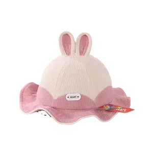 Pink and beige corduroy baby bucket hat with cute 3D bunny ears and heart label