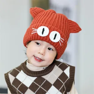 Winter knit baby hat with cartoon cat ears and big eyes embroidery in orange ribbed style