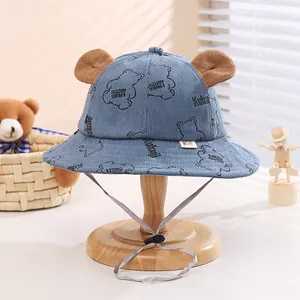 Detail of blue corduroy baby bucket hat with plush bear ears and adjustable chin strap