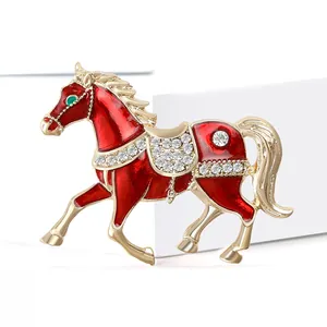 Exquisite gold-plated horse brooch with red enamel and sparkling white rhinestones