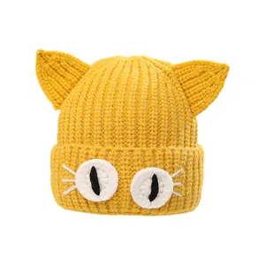 Handmade yellow knit winter hat for babies with cute 3D cat ears and cartoon eye details