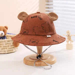 Close-up of brown corduroy baby bucket hat with cute bear ears and adjustable chin strap