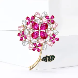 Elegant gold-tone hydrangea flower brooch with pink and green crystals on white display