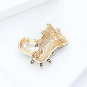 Back view of gold Christmas stocking brooch with textured mesh and secure safety pin