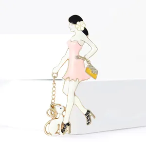Fashionable enamel brooch featuring a stylish lady with a small white dog and gold chain