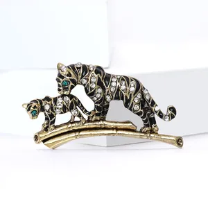 Vintage gold tiger and cub brooch with black enamel and rhinestones on bamboo branch