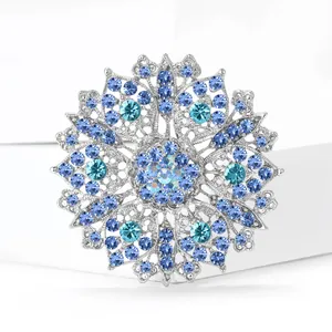 Exquisite silver-colored crystal flower brooch with hollow design and blue rhinestones