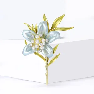 Elegant light blue lily flower brooch with white pearls and sparkling rhinestones