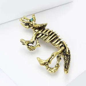 Spilla vintage scheletro dinosauro Triceratops dorato con occhio in strass verde
