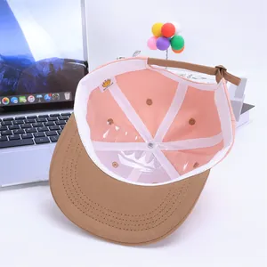 Contrast color baseball cap for kids featuring a flat brim and palm embroidery detail