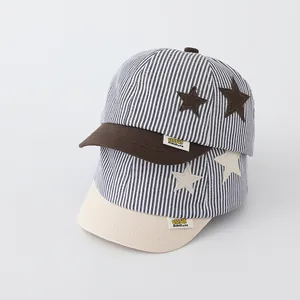 Detailed close-up of striped baby baseball caps with star patches and logo label