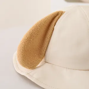 Close-up of baby sun hat showing soft cotton texture and plush 3D animal ear details