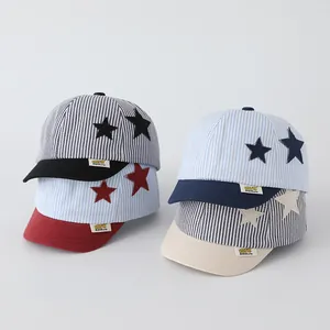 Close-up of baby striped baseball caps featuring star patches and yellow fabric labels