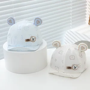 Detail of baby baseball cap featuring 3D ears and cute bear heart prints on soft cotton
