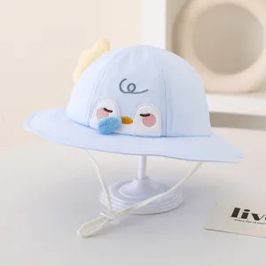 Detail of baby sun hat featuring penguin embroidery and adjustable white drawstring