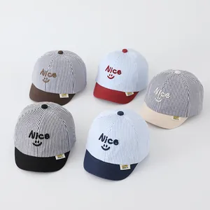 Detailed collection of five striped baby baseball caps with Nice smile embroidery