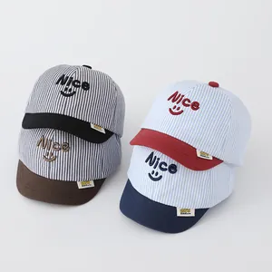 Detail of striped baby baseball caps with soft brims and 3D Nice embroidery in four colors