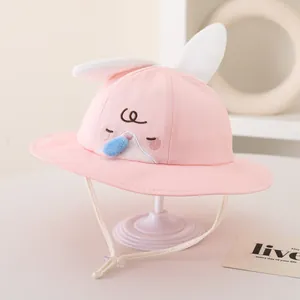 Detailed view of pink baby bucket hat with rabbit ears, embroidery and chin strap