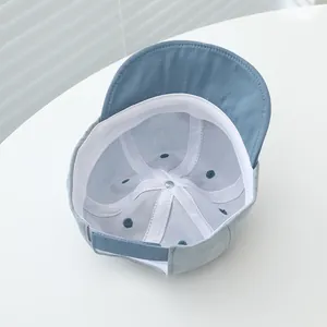 Detail view of toddler baseball cap interior with white lining and adjustable strap