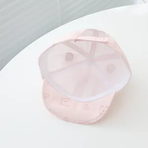 Detail view of pink baby baseball cap showing breathable mesh lining and adjustable strap