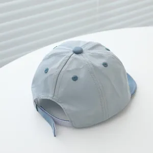 Detail of adjustable velcro strap on light blue cotton baseball cap for toddlers