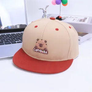 Detailed close-up of a color-blocked capybara embroidery on a flat-brimmed baseball hat