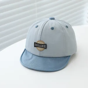 Detail of baby soft-brim baseball cap with American College vintage embroidery