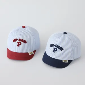 Detail shot showing the embroidered 'HI-BABY' and 'P' on striped cotton baby baseball caps