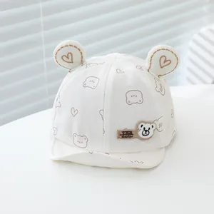 Detail of baby cotton baseball cap featuring bear ears and cute heart patterns