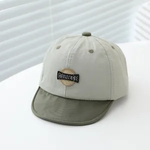 Detail of baby soft-brim baseball cap with College American embroidery and contrast colors
