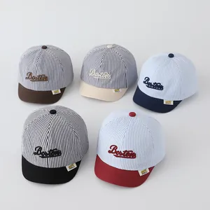 Detail of striped baby baseball caps featuring Boston embroidery in five color options