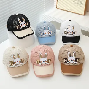 Detail view of colorful mesh kids baseball caps with cute cartoon bunny patches