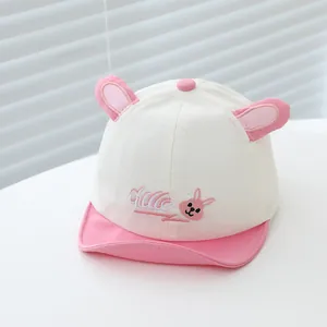 Détail de la casquette bébé avec visière souple, oreilles de lapin et broderie