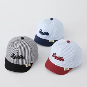 Detailed flat lay of striped baby baseball caps with Boston embroidery and soft brims