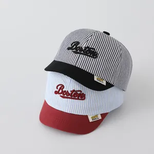 Detail of striped baby baseball caps with Boston embroidery and soft brims in two colors
