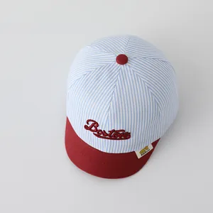 Detail of baby striped baseball cap with Boston embroidery and soft red brim edge