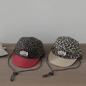 Child leopard print baseball cap with OKAY patch and adjustable rope detail
