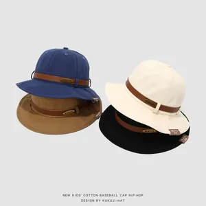 Stack of children's cotton bucket hats in blue, brown, beige and black colors